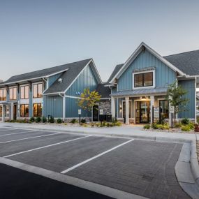 Exterior of the apartment building with a parking lot in front of it