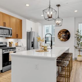 Open kitchen with a large white island with a countertop