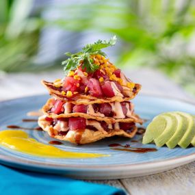NEW! Tuna Tostada Stack - Ahi tuna poke layered with crispy tortillas, drizzled with a zesty lime aioli, served with an avocado lime sorbet.