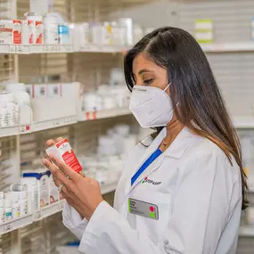 Pharmacist with mask selecting medications