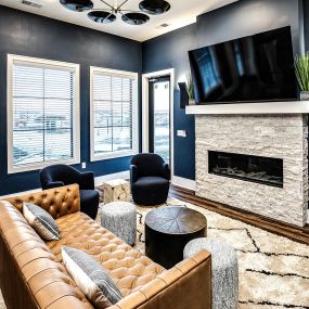 Resident Lounge Area with Fireplace, Bar, and Kitchen Area at Fireside at Waukee in Waukee, IA