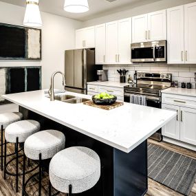 Studio, one, and two-bedroom apartment homes with stainless steel appliances, quarts countertops, designer cabinetry, large kitchens, luxury vinyl plank flooring, high vaulted ceilings, high-end lighting, in-unit washer and dryer, and energy efficient windows at Fireside at Waukee in Waukee, IA