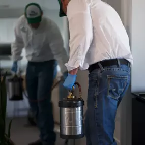 A First Line Pest Defence technician diligently applying pest control treatment indoors, ensuring comprehensive protection for residential spaces. This image highlights our professional service in managing and eliminating household pests.
