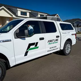 White First Line Pest Defense truck at a home, ready for expert pest control service.