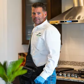 A uniformed and trusted First Line Pest Defence technician in a client's home, representing our company's commitment to professional, reliable, and effective pest management solutions in the Boise, ID area.