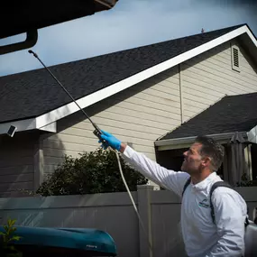 A professional technician from First Line Pest Defence performs a comprehensive exterior pest control service on a residential property in Caldwell, ID. This 