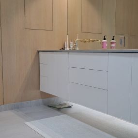 White rift oak combined with white slab doors . Clean and contemporary.  Push to open hardware.