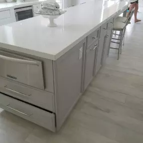 Top row of cabinets are a great way to to make your kitchen cabinets stand out, when you have a high ceiling.  This kitchen was 10 feet height. We started of with normal height cabinets and then added a top row of  glass cabinets with ligths inside and a nice hood trim. Also we added a nice crown molding to trim it up. Customer decided to Reuse the existing appliances.  For countertop we used premium 
Calacata quartz and full  tile backslash.