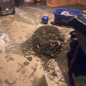 Pictured here is Trade Lake Wisconsin water damage restoration in a basement.  As you can see in this picture, we are scraping the concrete floor before we install the new carpet.