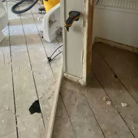 Pictured here is Grantsburg water damage in a kitchen.  As this picture shows, we are in the process of replacing the subflooring and sheetrock walls.