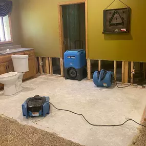 Pictured here is Webster Wisconsin water damage restoration in a lower-level entertainment room.  Visible in the picture is a sink.