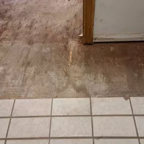 Pictured here is Webster Wisconsin water damage in a kitchen.  For this kitchen, we removed the floor tile in the water-damaged areas.  Next, we need to replace the subflooring.