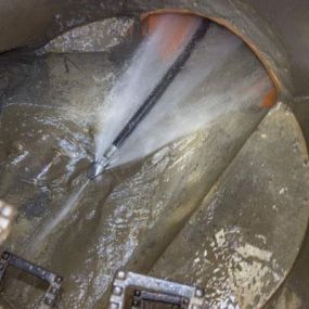 A photo of a commercial drain cleaning taking place with a drain water jetter