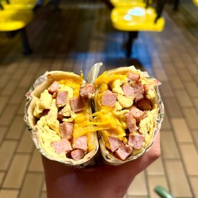 Scrambled eggs, grilled ham, and fresh Cheddar cheese all wrapped in a soft flour tortilla.