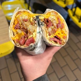 Scrambled eggs, crispy bacon, crispy potatoes, and fresh Cheddar cheese all wrapped in a soft flour tortilla.