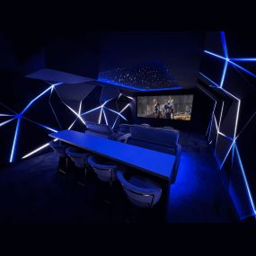 Stunning immersive home cinema installation featuring three-dimensional wall panels with integrated, dynamic LED lighting.