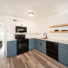 Remodeled apartment homes featuring premium appliances, custom cabinetry, lighting, and LTV flooring at Greenway Flats in Fayetteville, AR.