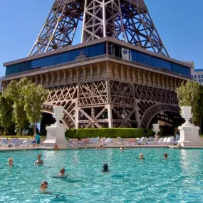 Pool á París main pool view. You won’t get a view like this at any other Las Vegas pool. Pool á París is located right underneath the hotel’s Eiffel Tower replica at Paris Las Vegas, positioned in the heart of the Las Vegas Strip. Take rest and relaxation to the next level with a lounge chair, daybed or cabana rental at Pool á París. The romantic atmosphere paired with various amenities will leave you rejuvenated and ready for the evening on the famed Las Vegas Strip.