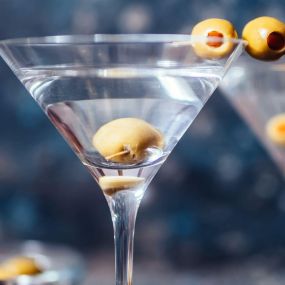 Close-up of a classic dry martini with olives at The Count Room; an intimate speakeasy bar offering boozy cocktails and savory bites. Located inside Bugsy & Meyer’s Steakhouse at the Flamingo Hotel and Casino. Step back in time - The Count Room captures the vintage elegance of the speakeasy era with a modern twist. Enjoy shareable plates and crafted cocktails. Rhythm & Booze - Prohibition’s over, cats. Practice your 21st Amendment rights in style with a pleasing assortment of handcrafted cocktai