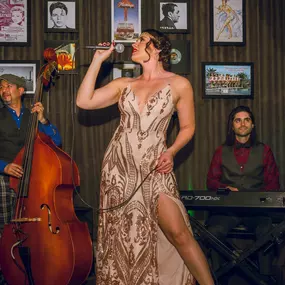 A woman sings while musicians play bass and keys at The Count Room; an intimate speakeasy bar offering boozy cocktails and savory bites. Located inside Bugsy & Meyer’s Steakhouse at the Flamingo Hotel and Casino. Step back in time - The Count Room captures the vintage elegance of the speakeasy era with a modern twist. Enjoy shareable plates and crafted cocktails. Rhythm & Booze - Prohibition’s over, cats. Practice your 21st Amendment rights in style with a pleasing assortment of handcrafted cock