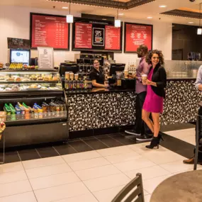 Multiple people enjoying their drinks Inside Sips Coffee and Tea.