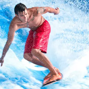 Man riding the FlowRider at The Scene Pool Deck at Planet Hollywood. Rooftop pools, Las Vegas Strip views - what more could you really ask for? Planet Hollywood features the ultimate Las Vegas poolside social retreat at The Scene Pool Deck. Capture your incredible Vegas Pool Instagram moment in a cabana or as you hang ten on the Strip’s only professional free-standing wave, the FlowRider.