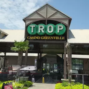 Trop Casino Greenville logo. Tropicana Greenville Casino - This spacious land-side casino is located in Historic Downtown Greenville, Mississippi. Tropicana Greenville is nestled in the heart of Greenville's Entertainment District and boasts beautiful views of Lake Ferguson. Our Las Vegas-style casino is home to hundreds of slot machines, exciting electronic table games, and much more.