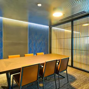 A conference room with a long table and chairs