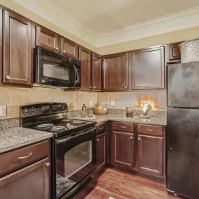 Kitchen with black appliances and granite countertops