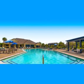 Swimming pool with chairs and umbrellas at the club house