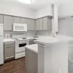 Spacious bright kitchen with large countertop and bar