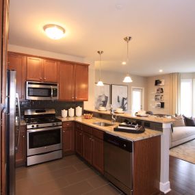 A kitchen with wooden cabinets and stainless steel appliances