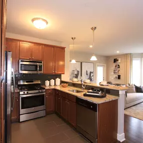 A kitchen with wooden cabinets and stainless steel appliances