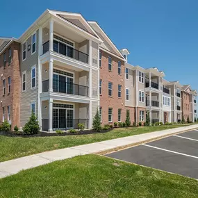 Exterior of 3-story apartment building with pathway in front