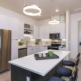 a kitchen with stainless steel appliances and quartz counter tops