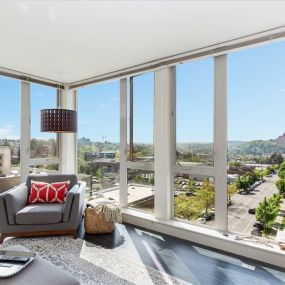 Living room with floor to ceiling windows at Decibel on 12th in Seattle, WA