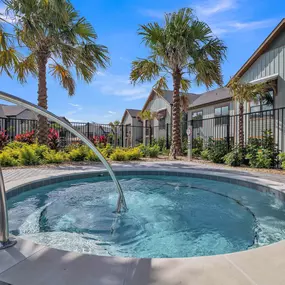 A hot tub with palm trees in the background