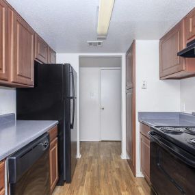 kitchen with cabinetry, refrigerator, and stove