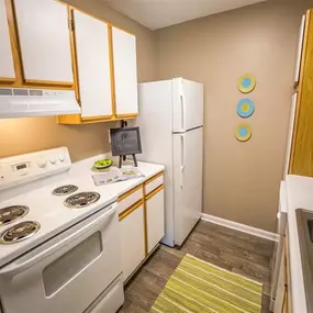 Kitchen with full appliances, ample cabinetry, and hardwood-style flooring