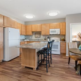 Kitchen with Eat-in Island at Legacy Commons at Signal Hills 55+ Living