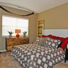 Model bedroom with plush carpet and large window