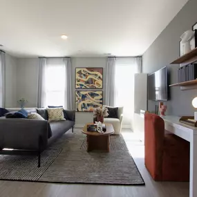 A living room with gray walls and a brown couch