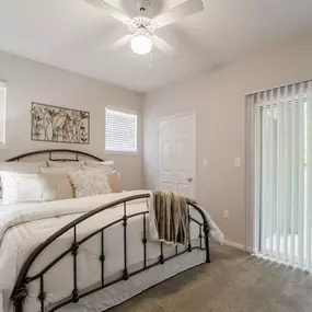 Bedroom with walk-in closet and private patio