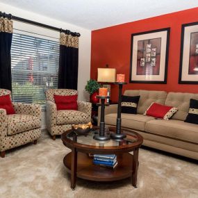 living room with sofa and two single chairs