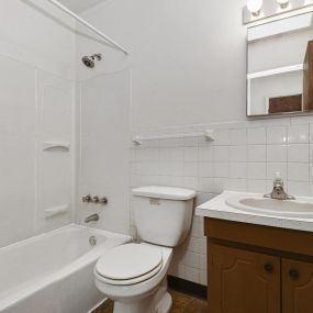 A bathroom with a sink toilet and bathtub