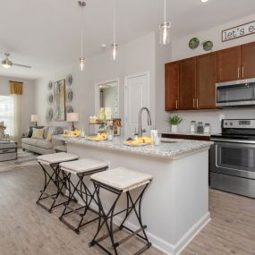 modern kitchen with dark brown cabinetry and island