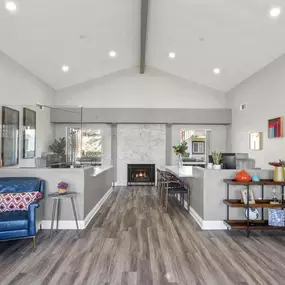 a living room with a fireplace and a blue chair