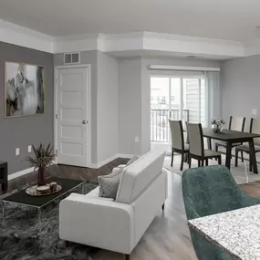 A living room with a couch table and chairs