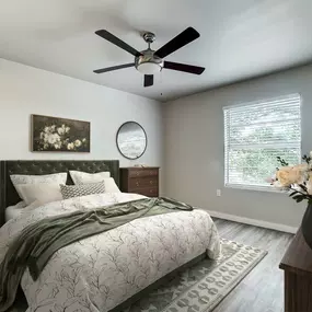 a bedroom with a bed and a ceiling fan