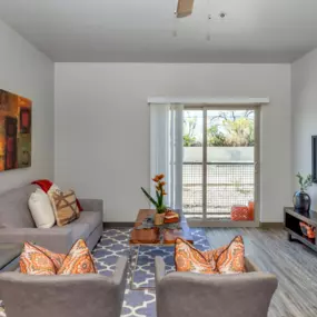 Living Room with Sliding Glass Doors Leading Out to Patio Area